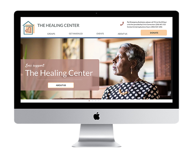 photo of a desktop computer showing the healing center homepage on the screen